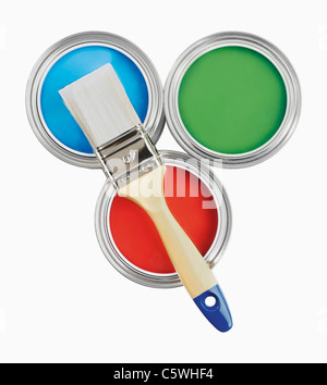 Three paint cans and paint brush on white background Stock Photo