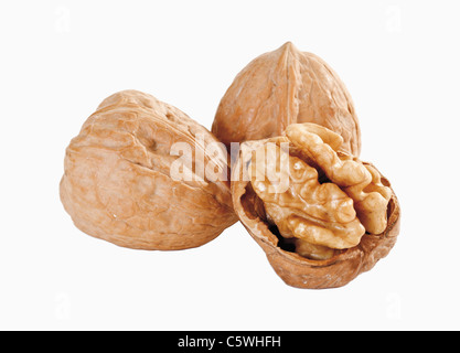Whole and peeled walnuts against white background, close up Stock Photo