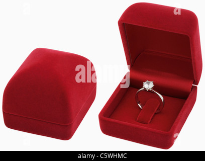 Red jewellery case with ring on white background, close up Stock Photo