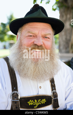 Germany, Bavaria, Upper Bavaria, Bavarian man wearing traditional costume, smiling, portrait, close-up Stock Photo
