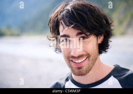 Germany, Bavaria, Young man smiling, portrait Stock Photo