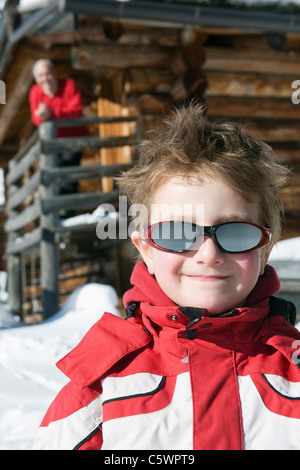 Italy, South Tyrol, Seiseralm, Boy (4-5) portrait, grandfather in background, close-up Stock Photo