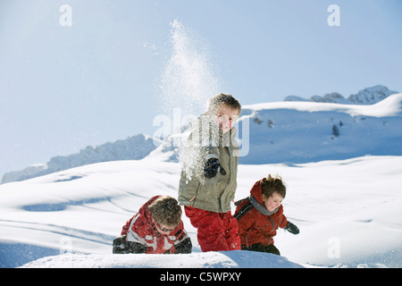 Italy, South Tyrol, Seiseralm, Children throwing snow in the air Stock Photo