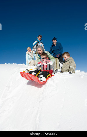 Italy, South Tyrol, Seiseralm, Family sledding Stock Photo
