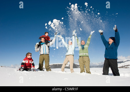 Italy, South Tyrol, Seiseralm, Family cheering in snow Stock Photo