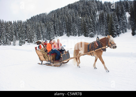 Italy, South Tyrol, Seiseralm, Family riding in sleigh Stock Photo