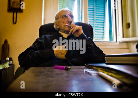 Don Andrea with the inevitable cigar in an interview. Don Andrea Gallo, Genoa, Italy Stock Photo