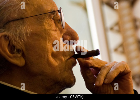 Don Andrea with the inevitable cigar in an interview. Don Andrea Gallo, Genoa, Italy Stock Photo