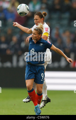 Eugenie Le Sommer of France (9) and USA team captain Christie Rampone jump for a header during a 2011 Womens World Cup match. Stock Photo