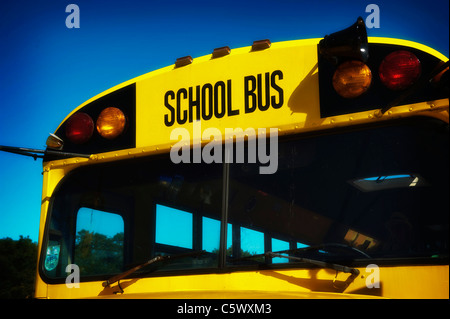 American school bus, windscreen and sign, yellow against blue sky. Stock Photo