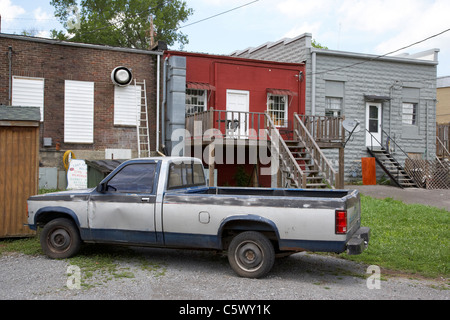 old pickup truck in parked at rear of shops and stores access main street Lynchburg , tennessee , usa Stock Photo