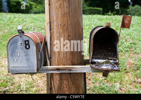 empty old used american private mailboxes one with birdsnest in Lynchburg  tennessee usa rural remote location postal service unused disused Stock Photo
