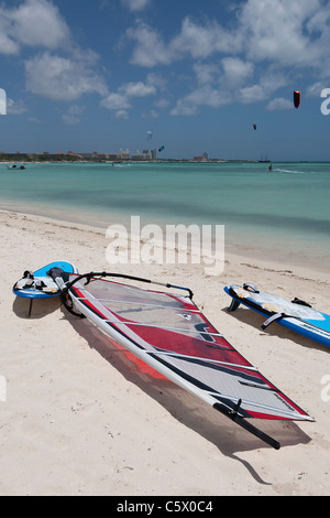 Windsurfs on Palm Beach, Aruba, Dutch Caribbean with a kite surfer in background Stock Photo