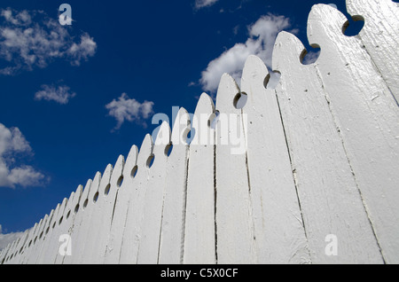 White wooden fence and blue sky with clouds Stock Photo