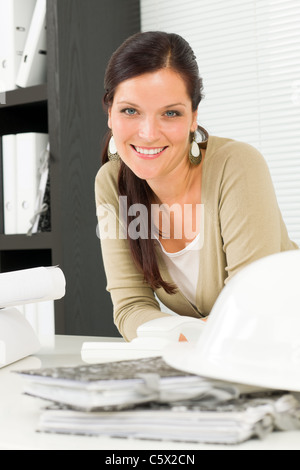 Office relaxation pose professional architect woman leaning over table Stock Photo