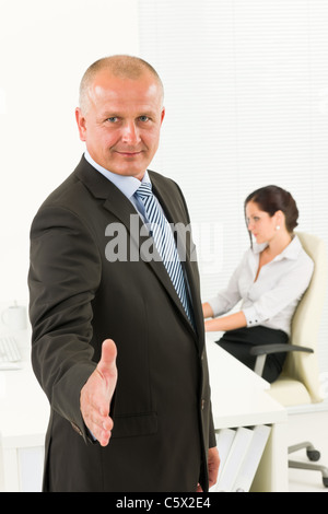 Professional senior businessman handshake in office with secretary Stock Photo