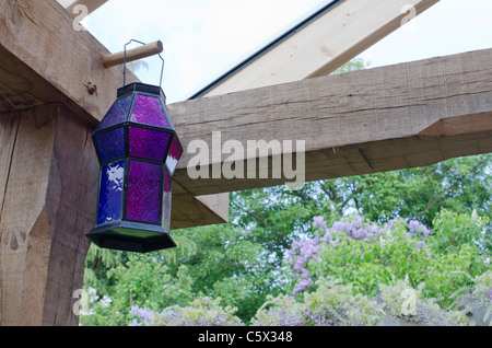 Blue lantern hanging in a pergola Stock Photo