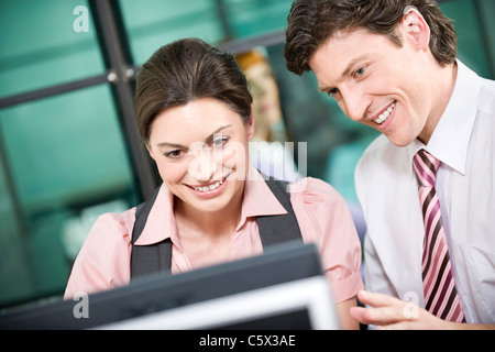 Germany, Munich, Co-workers using laptop, portrait Stock Photo