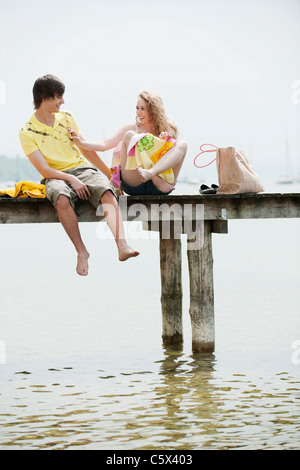 Germany, Bavaria, Ammersee,Young couple on jetty, portrait Stock Photo