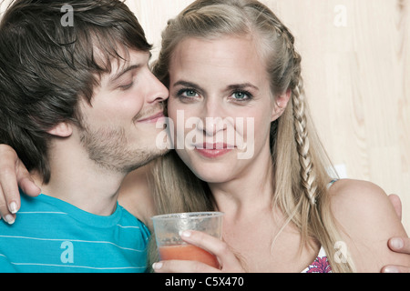 Germany, Cologne, Young couple embracing, portrait Stock Photo