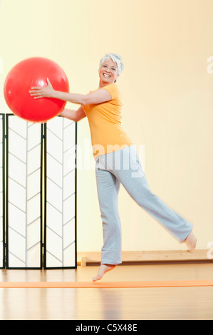 Senior woman holding gymnastic ball, portrait Stock Photo