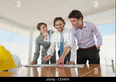 Architects in office working on plans Stock Photo