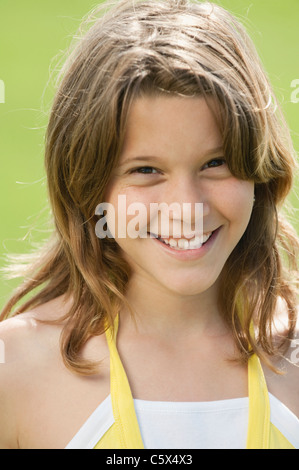 Girl (10-11) smiling, portrait, close-up Stock Photo