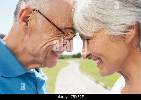 Spain, Mallorca, Senior couple standing head to head, side view, portrait, close-up Stock Photo