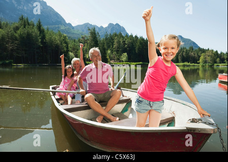 Italy, South Tyrol, Grandparents and children (6-7) (8-9) in rowing boat on lake, portrait Stock Photo