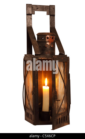 Old lamp with burning candle isolated on white background Stock Photo