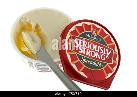 Tub of Spreadable Seriously Strong Mcelland cheese spread and a portion on a knife. Stock Photo