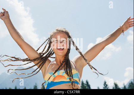Italy, South Tyrol, Girl (13-14) with dreadlocks, cheering, portrait Stock Photo