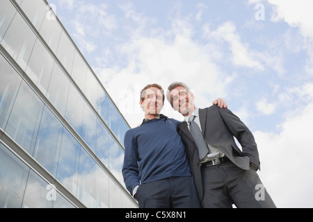 Germany, Hamburg, Two businessmen smiling, low angle view Stock Photo
