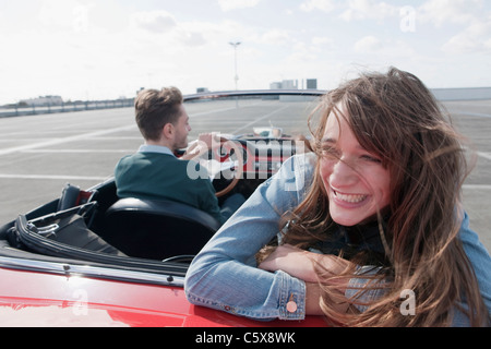 Germany, Berlin, Couple driving in cabriolet, smiling, portrait Stock Photo