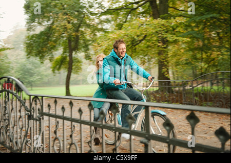 Germany, Bavaria, Munich, English Garden, Couple riding bicycle Stock Photo