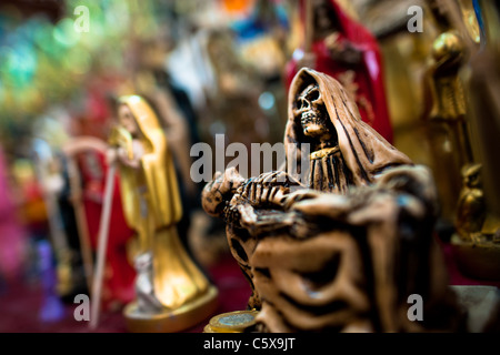 Figurines of Santa Muerte (Saint Death) sold in a witchcraft market in the center of Mexico City, Mexico. Stock Photo