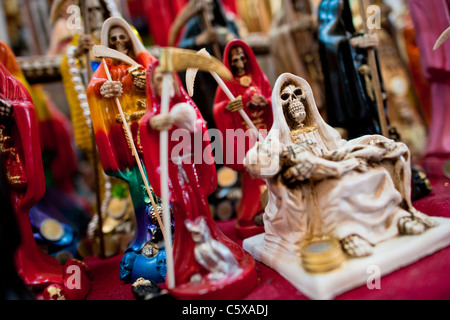 Figurines of Santa Muerte (Saint Death) sold in a witchcraft market in the center of Mexico City, Mexico. Stock Photo