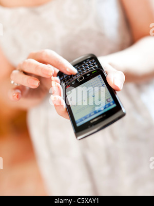 Woman using Blackberry Stock Photo