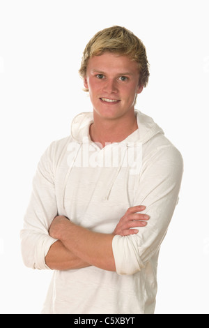 Young man, arms crossed, smiling, portrait Stock Photo