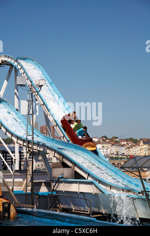 Having fun on the log ride on Brighton Pier in May Stock Photo