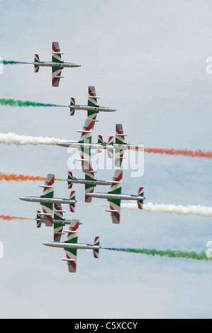 Italian airforce aerobatic display team Il Frecce Tricolori flying their Aermacchi MB339 jets perform an exciting cross over Stock Photo