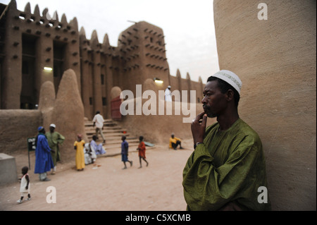 MALI, Djenne, Grand Mosque build from clay is UNESCO world heritage, muslim man wears a Boubou which is made from Damask fabric Stock Photo