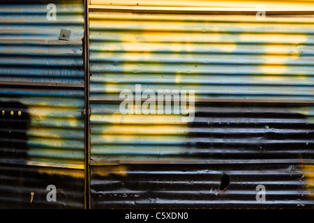 Spray painted corrugated metal door, UK Stock Photo