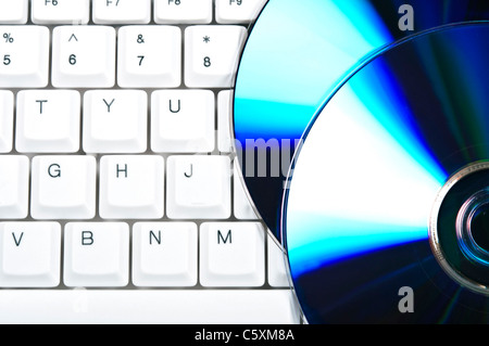 Cd on computer white keyboard Stock Photo