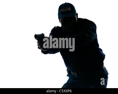 Silhouetted Afro American police officer aiming handgun isolated on white background Stock Photo