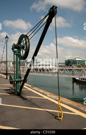 A vertical shot of a pulley crane on the quayside in Plymouth docks/marina Stock Photo