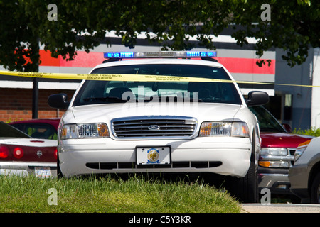 Police car with crime scene tape Stock Photo