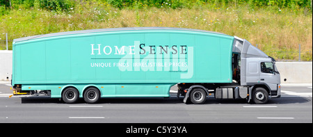 Side view streamlined aerodynamic shape of Home Sense retail  business hgv lorry truck power unit & trailer advertising & driving on M25 UK motorway Stock Photo