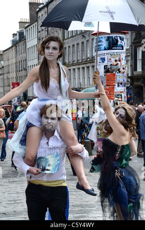 Cast members promote their Edinburgh Fringe play on the High Street. Stock Photo