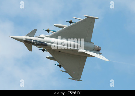 British military fighter aircraft Eurofighter Typhoon number ZJ700 rolls while displaying fully loaded at the 2011 Air Tattoo Stock Photo